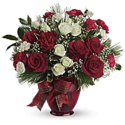 All dressed up in classic Christmas colors, this holiday floral arrangement is delivered in a delightful ruby red vase tied with plaid taffeta ribbon. White pine, holly branches and red and white blooms keep the feeling festive.

White roses and red and white carnations are mixed with delicate white million star gypsophila, holly branches and white pine.
Presented in a deep red vase with plaid taffeta ribbon bow.